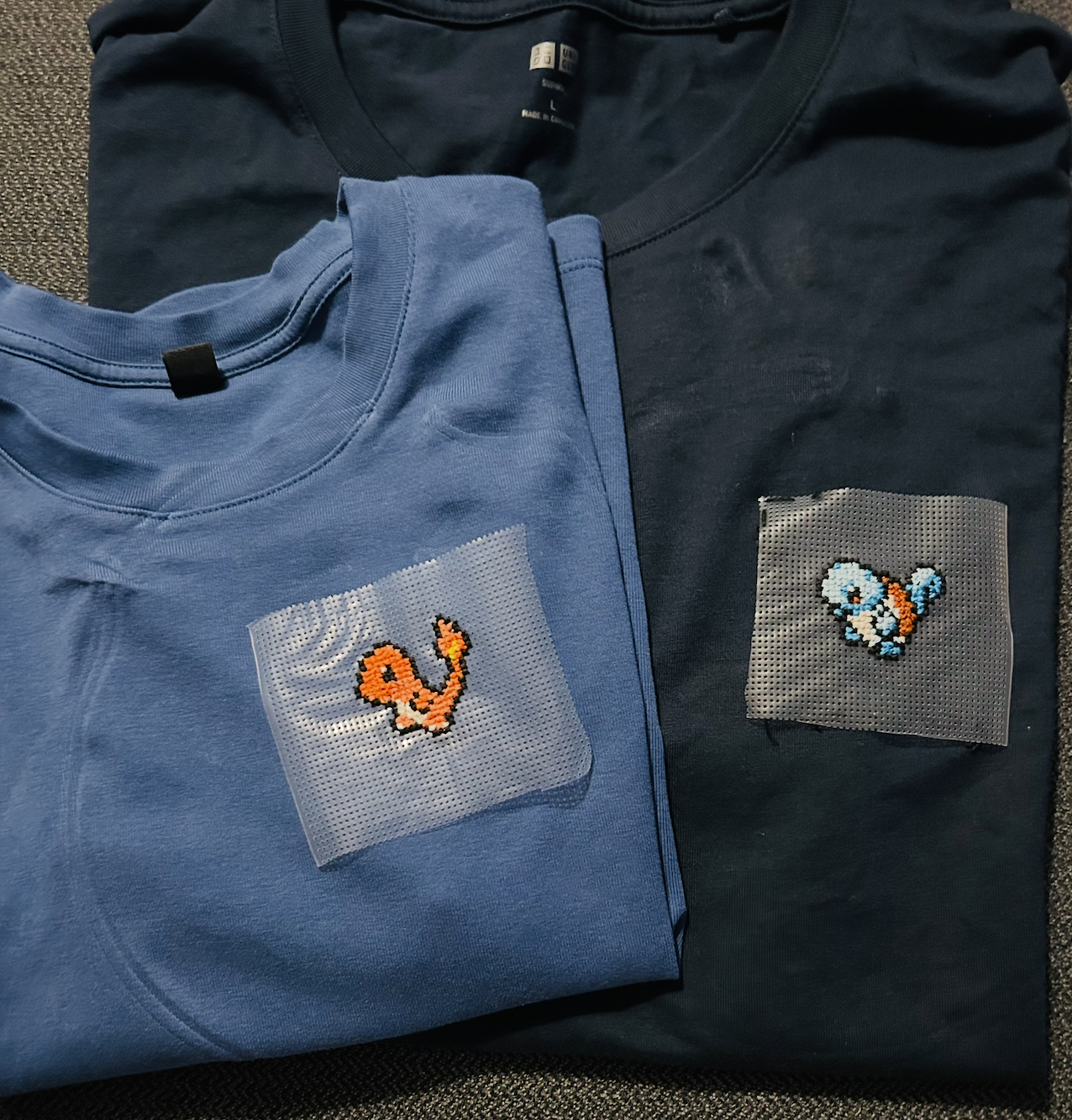 charmander and squirtle pokemon cross stitch on folded t-shirts