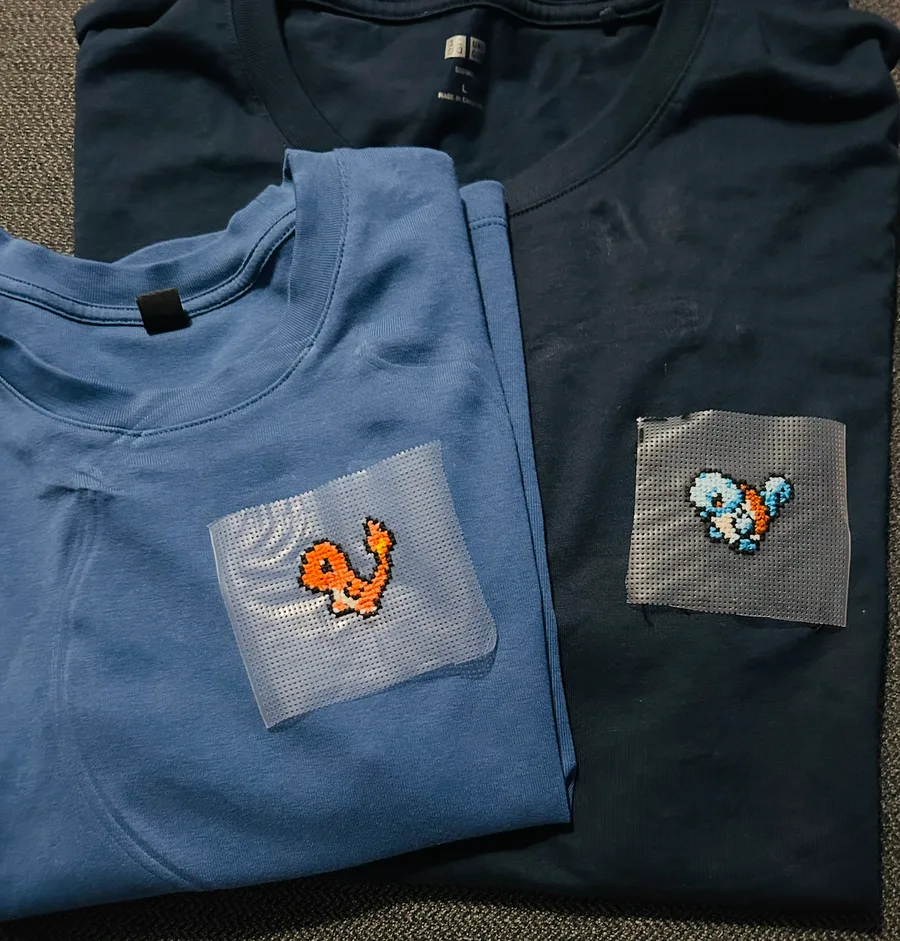 charmander and squirtle pokemon cross stitch on folded t-shirts